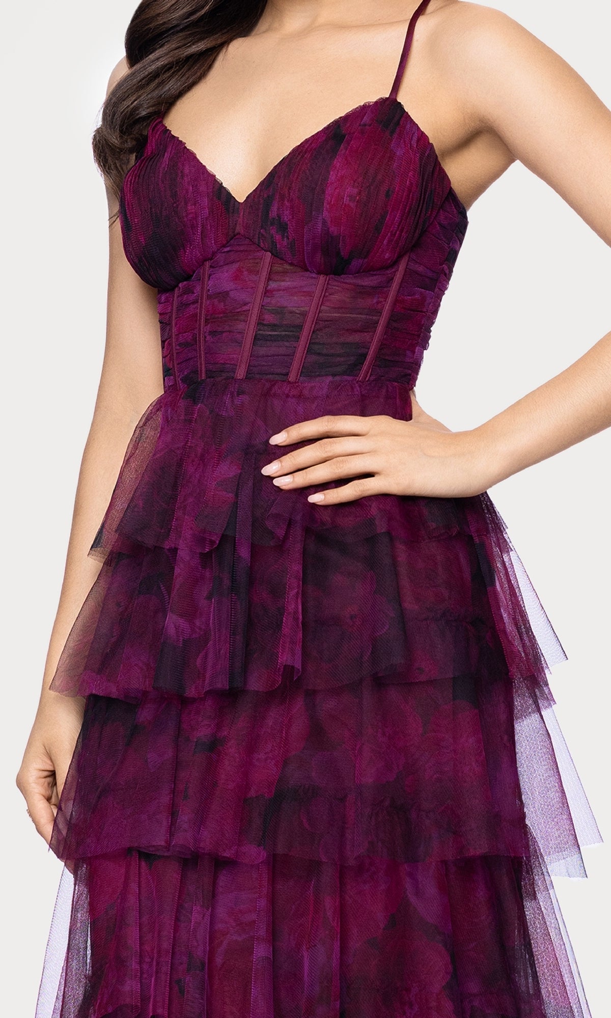 A woman wearing the Wine Red Ruffle Formal Gown (Blondie Nites 5778BN) with a fitted bodice and spaghetti straps, standing with one hand on her hip.